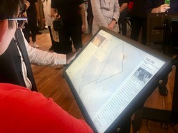 Exhibit visitors walk through the history of redlining in Mount Airy with maps provided by Azavea