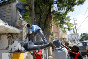Haitians pull out a body from the rubble of a school that collapsed after the earthquake that rocked Port au Prince on January 12. Ethical machine learning engages local communities. Photo Marco Dormino.