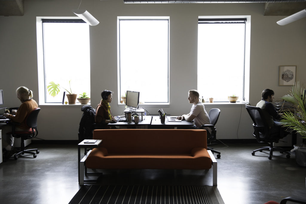 two employees at Azavea sitting at desks
